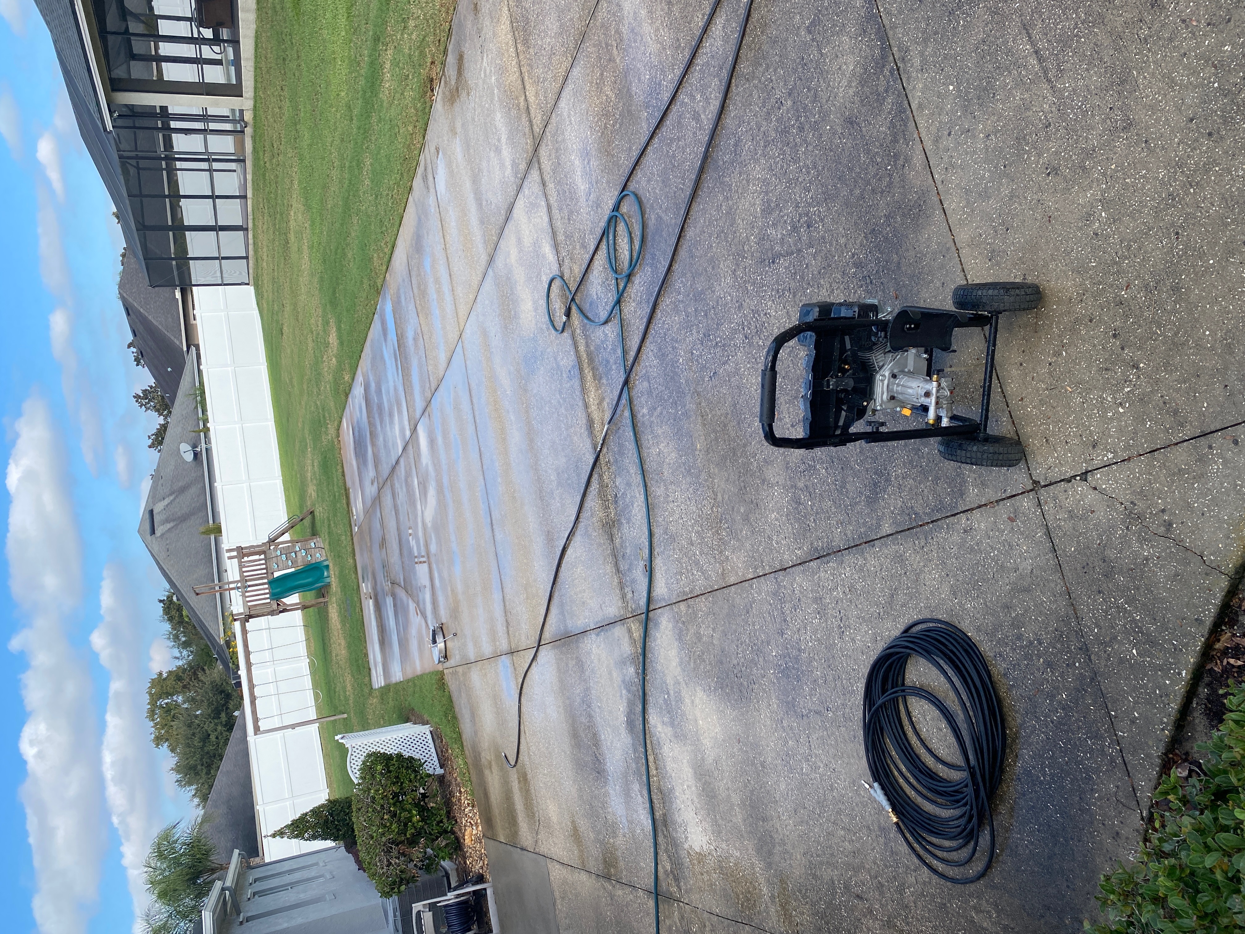 Driveway pressure washing equipment and cleaned concrete